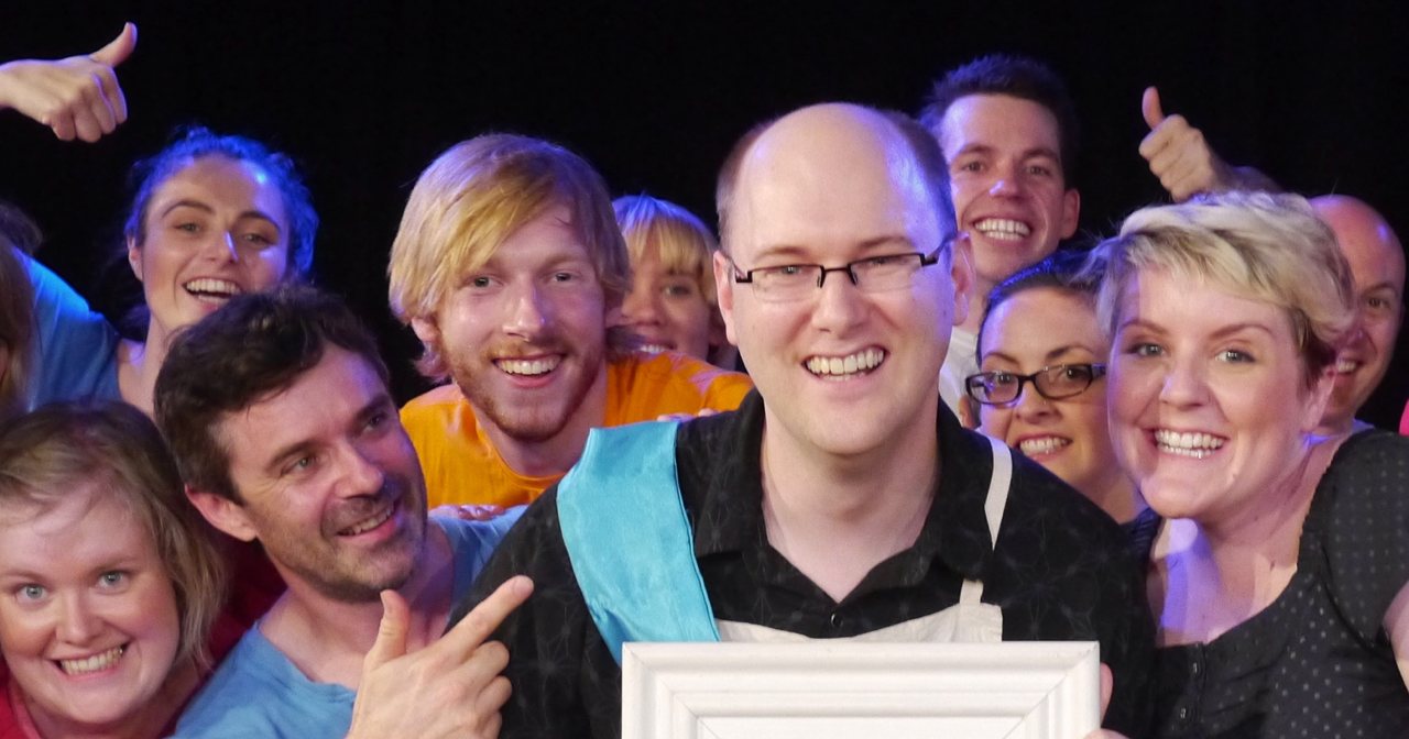 Kevin Yank, the Maestro™ winner for the week, is surrounded by his fellow players