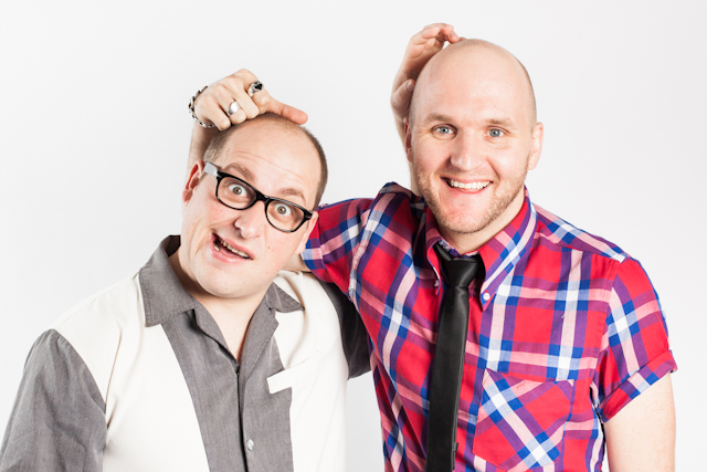 Jason Geary and Jimmy James Eaton appear to hold each other by the “hair” on their bald heads